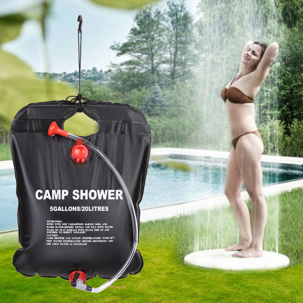 Person using a portable camp sola shower US outdoors 