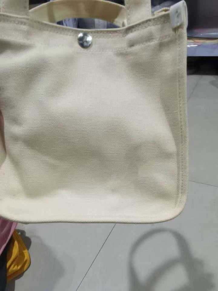 Beige Eco canvas tote bag in use,  perfect for shopping, travel, and casual wear.