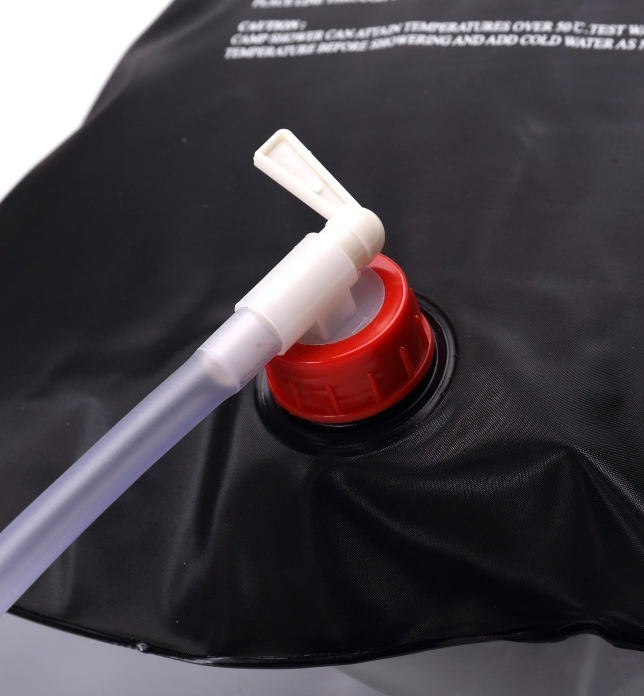 Black water bladder with a white valve and red cap