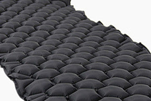 Compact eco inflatable sleeping pad for camping and hiking, lightweight cushion on trails