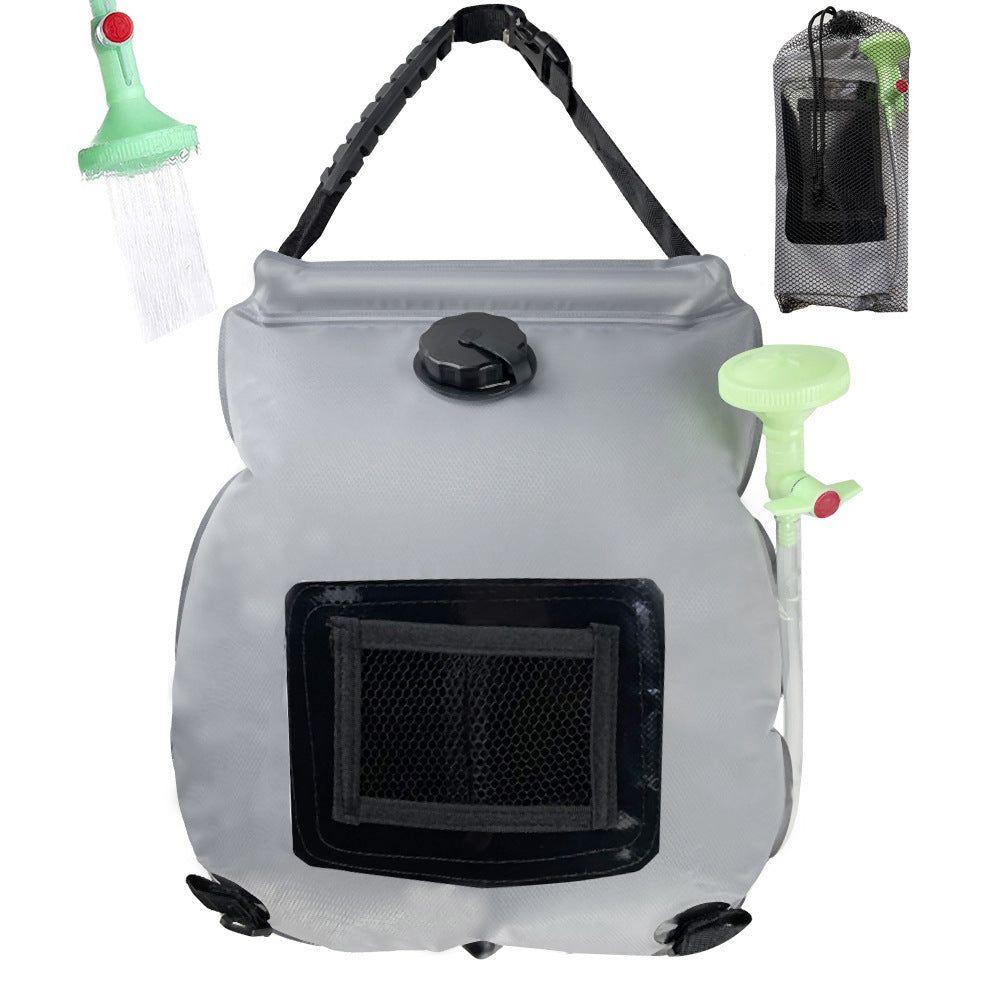 Portable solar shower system with a gray tank and green showerhead