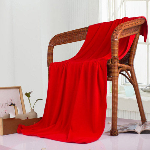 Red nano microfiber towel draped over a wicker chair 