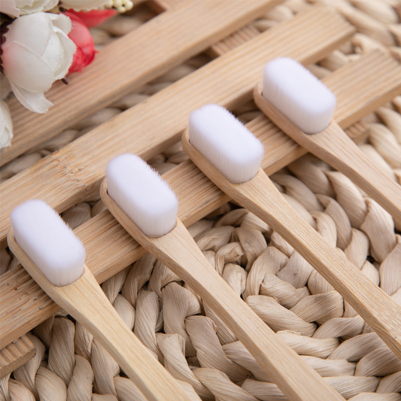 Set of wooden toothbrushes with white bristles