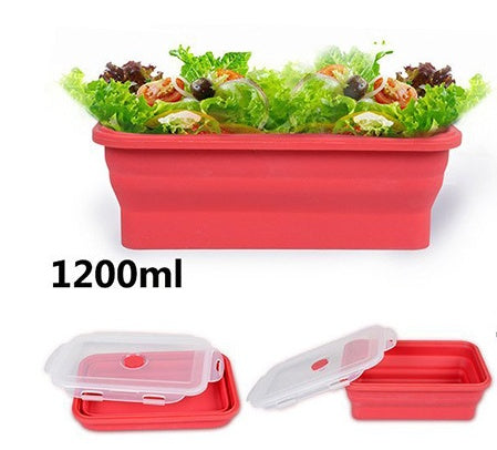 Red collapsible container with salad and a lid on a white background