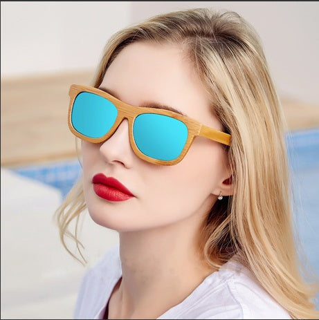 Woman wearing eco bamboo sunglasses with blue lenses.