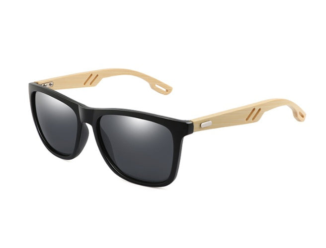 Sunglasses with black lenses and wooden arms on a white background