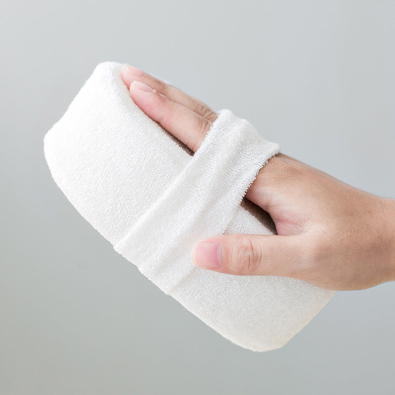 Women using eco loofah sponge for gentle exfoliation in the shower—natural, sustainable bath essential.