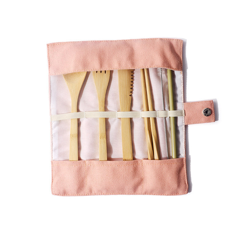 pink canvas pouch holding bamboo utensil set