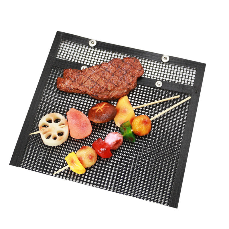 Black mesh grill mat with skewered vegetables and a piece of meat.