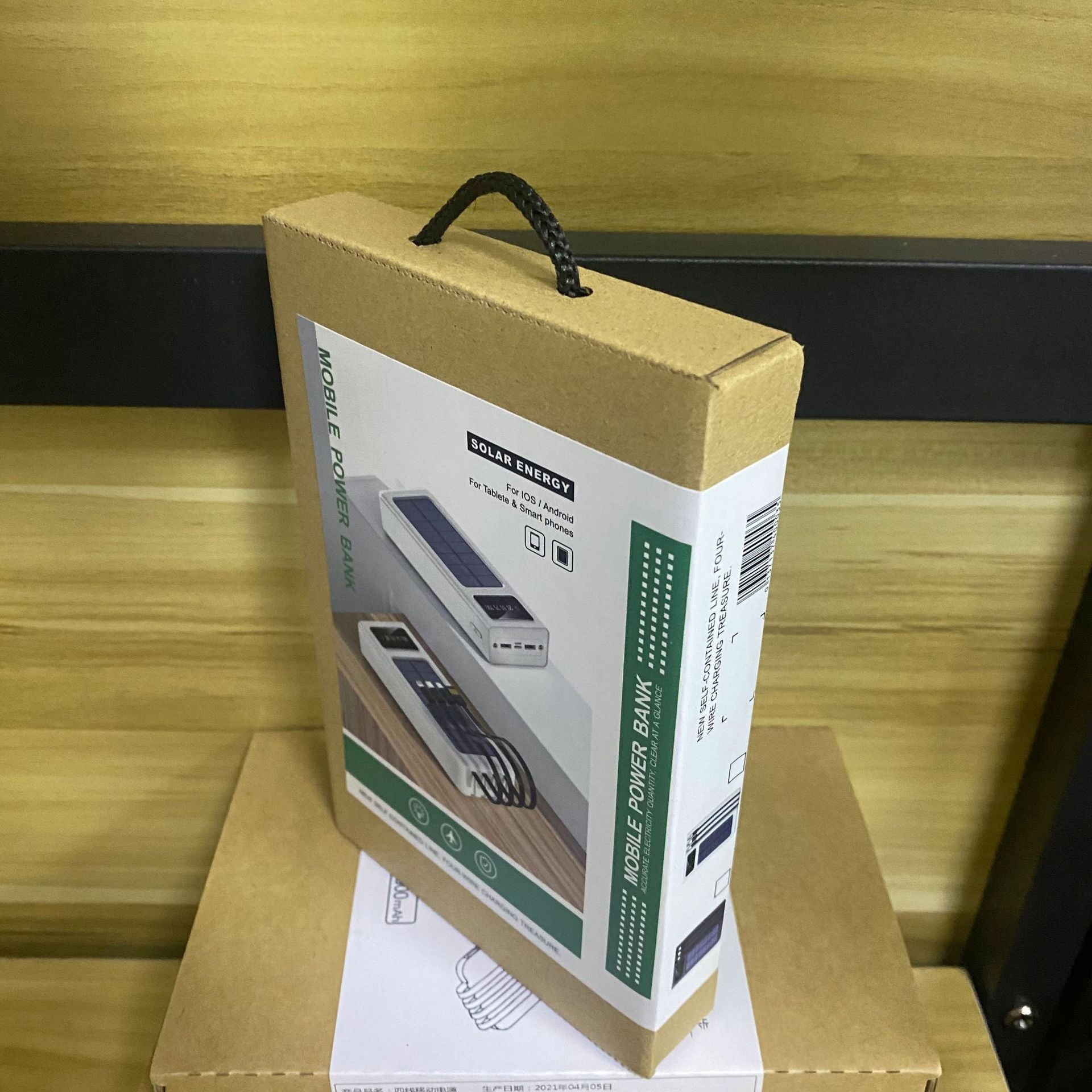 Cardboard box with a power bank on a wooden surface