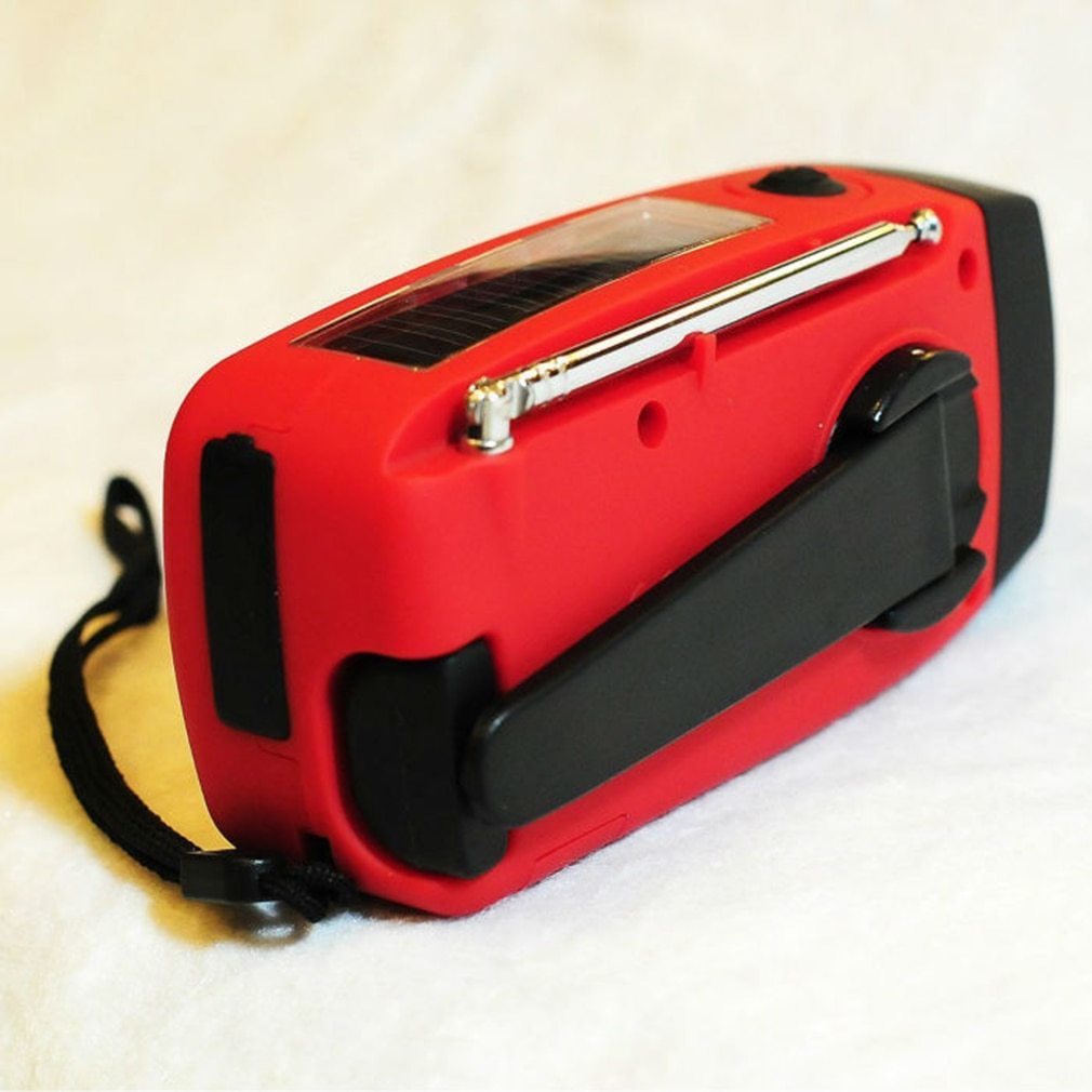 Red and black portable device with a solar panel on a light background