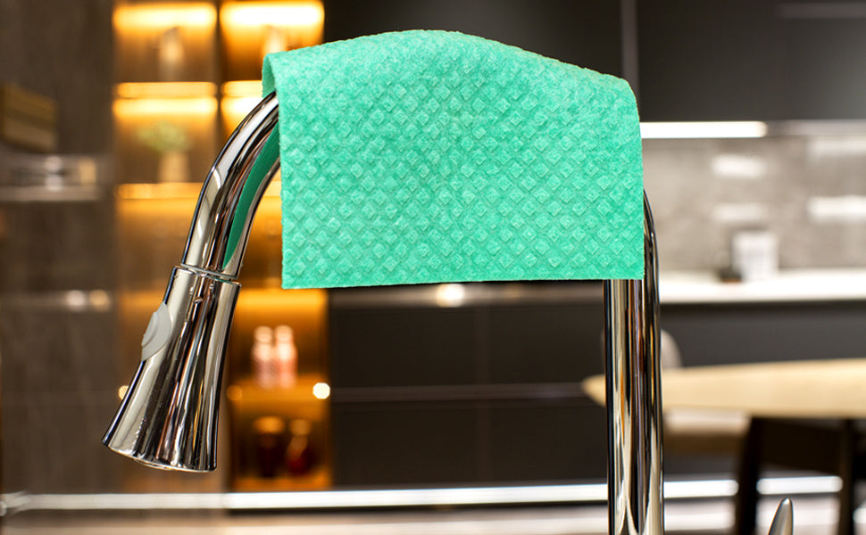 Green kitchen towel draped over a faucet in a Canada kitchen setting