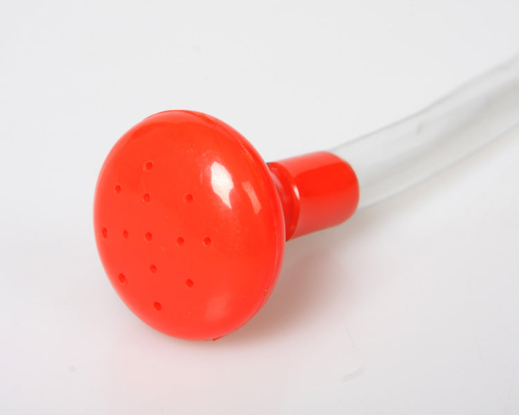 Red plastic shower head with a white hose on a white background