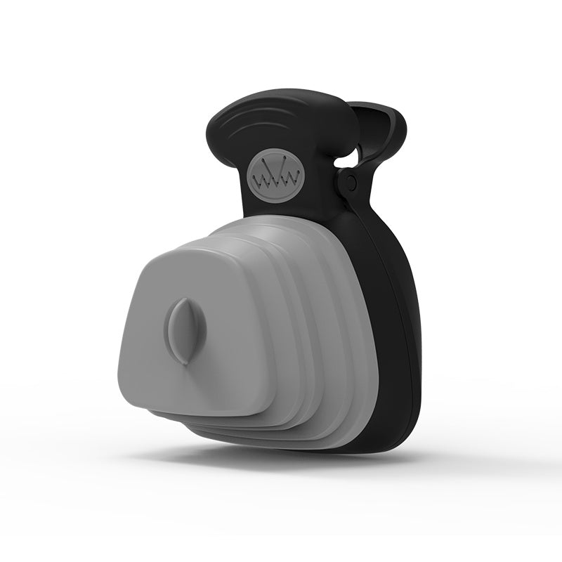 Black and gray silicone foldable dog scooper with a clip on a white background