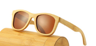 Wooden sunglasses with a brown lens on a wooden stand