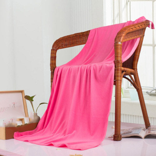Pink nano microfiber towel draped over a wicker chair  UK Camping gear