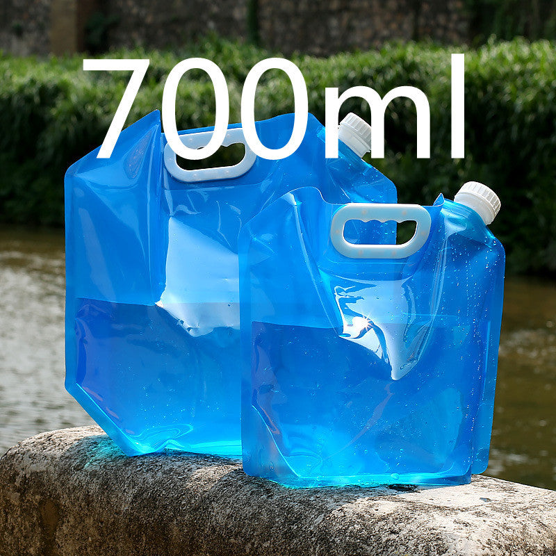 Two blue folding water containers with white caps on a stone ledge Canada outdoors.