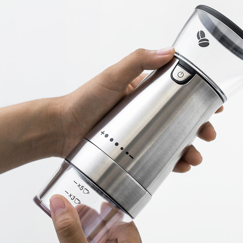 hands holding espresso-fine ground coffee from grinder