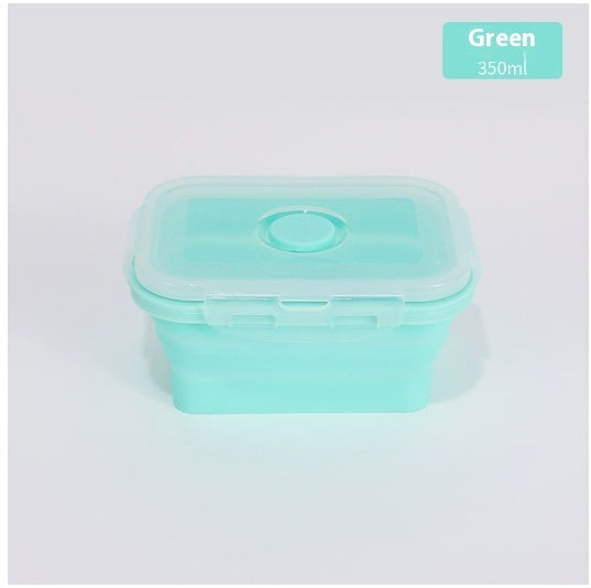 Green silicone food container with lid on a light gray background