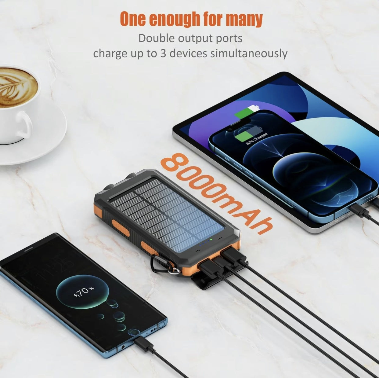 Solar power bank with two smartphones being charged on a marble surface with a cup of coffee.