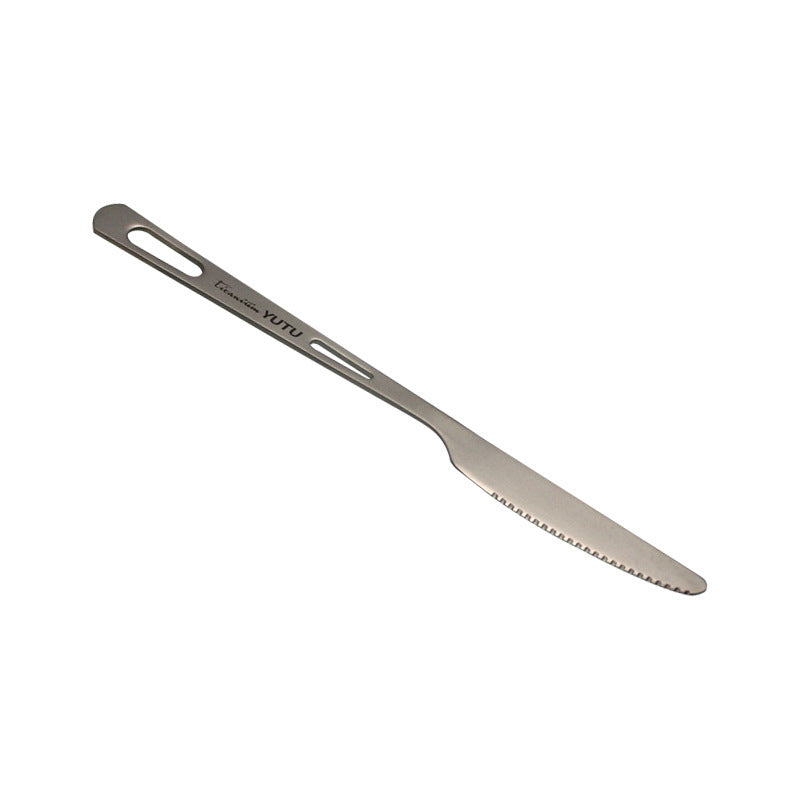pure titanium knife with serrated edge on a white background