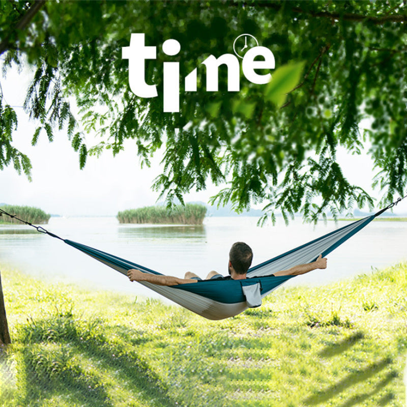 Person relaxing in a light weight eco hammock double-style—compact for hiking, comfy for relaxing.