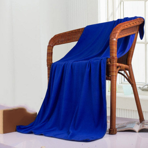 Blue soft microfiber towel draped over a wicker chair.